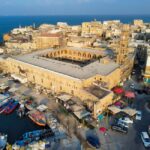 Stunning aerial shot of Acre harbor showcasing historic architecture and vibrant boats.