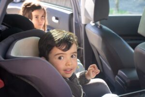 Two children sitting in a car, enjoying a family ride in Portugal.