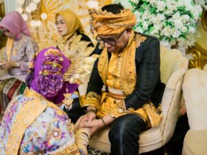 A traditional wedding ceremony in Kendari, Indonesia, showcasing vibrant attire and cultural rituals.