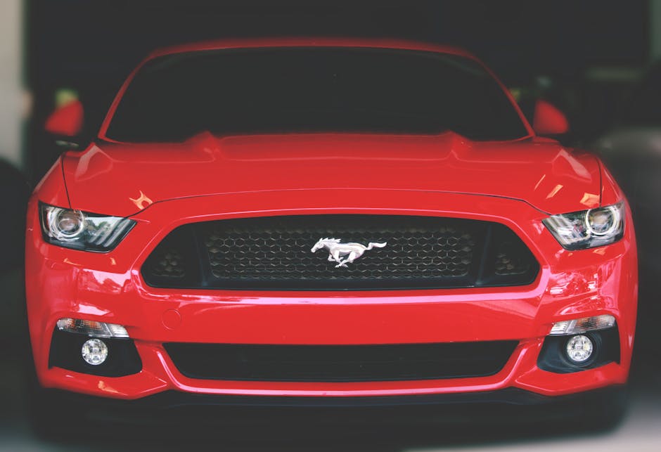 Bright red Ford Mustang showcased with a sleek front view in Ahmedabad.