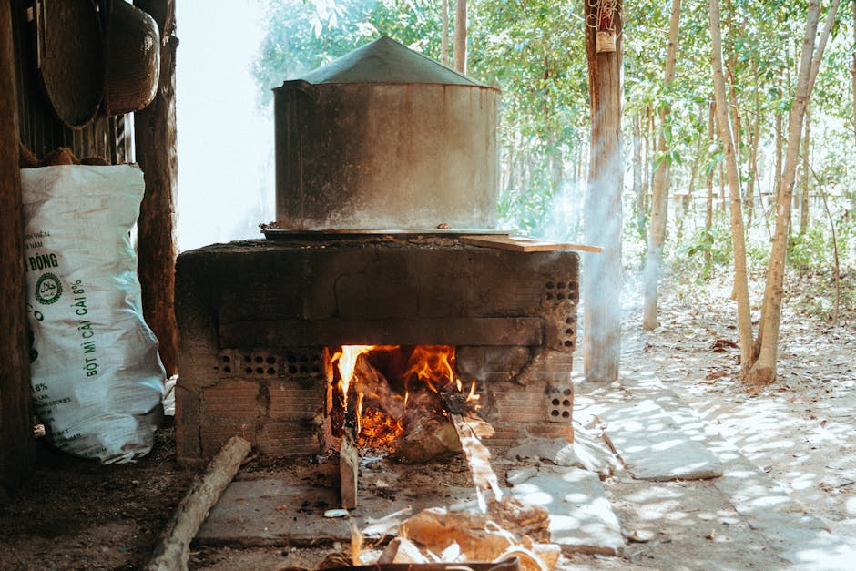 Traditional stove burning wood in a forest setting, Vietnam.