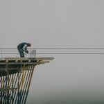 Worker on construction site framework against a cloudy sky in Denizli, Türkiye.