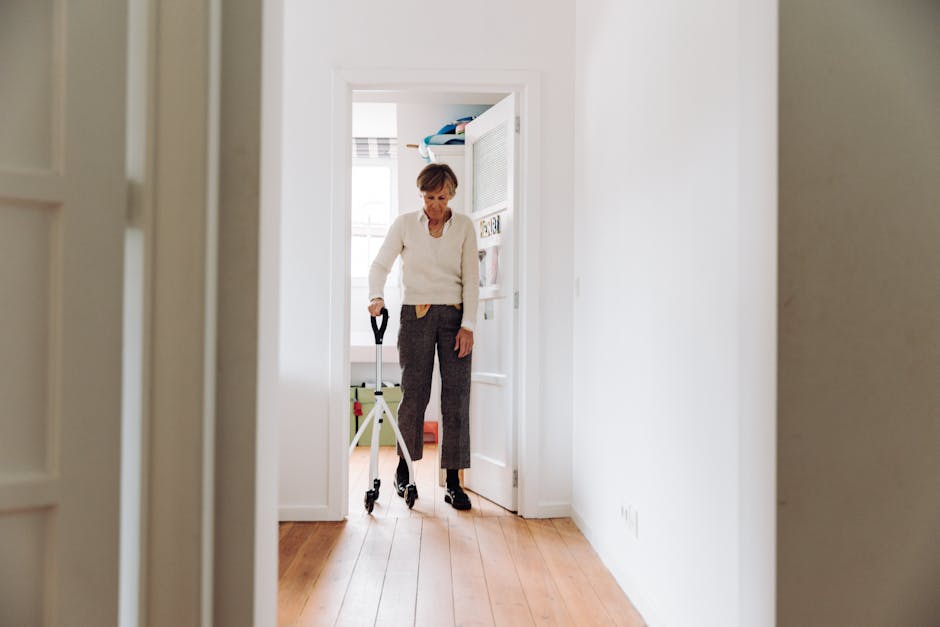 Senior adult using a rollator in a sunlit hallway, emphasizing mobility and independence.