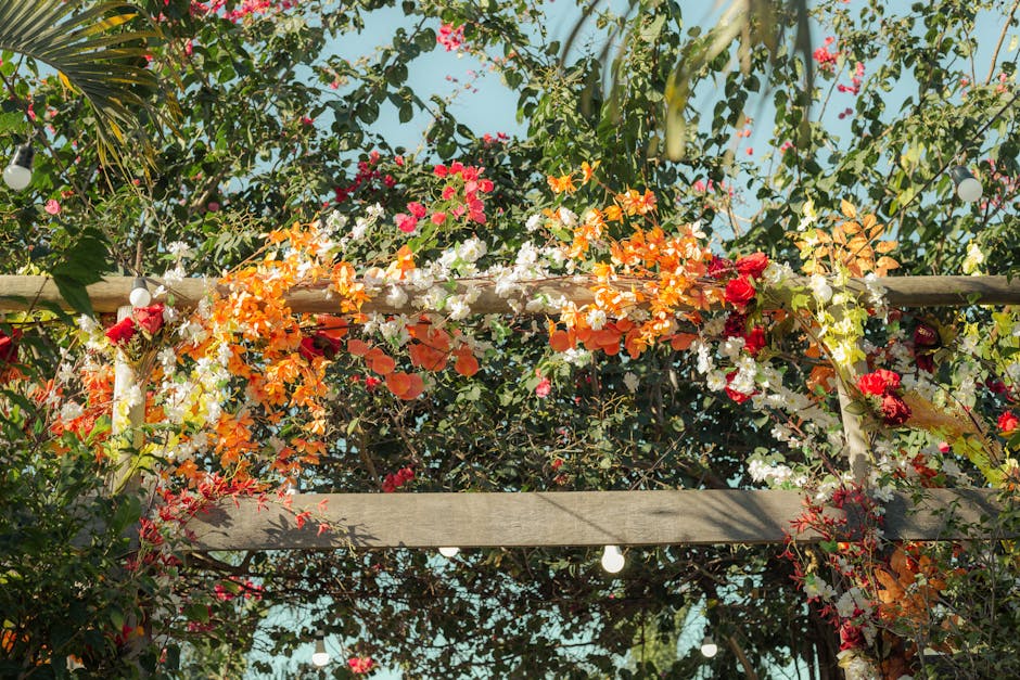 Beautiful wedding arch decorated with vibrant flowers in a tropical setting.