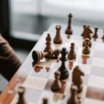 Close-up of a chessboard highlighting a pivotal moment with the king tipped over.