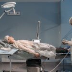 Surgical setup in a hospital room with medical staff and patient in sterile clothing.