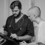 A doctor showing medical images to a patient in a hospital setting, highlighting care and consultation.