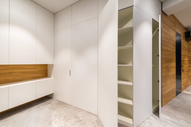 Bright and modern interior of an empty white closet with wooden accents.