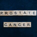 Text 'Prostate Cancer' on tiles against a dark blue backdrop promoting awareness.