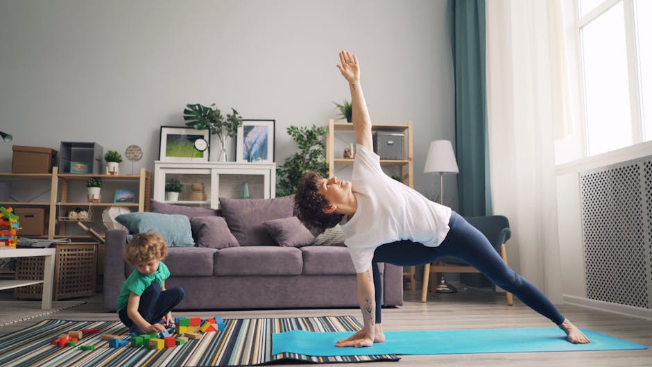 A mother stretches on a yoga mat while her child plays with blocks nearby in their living room.