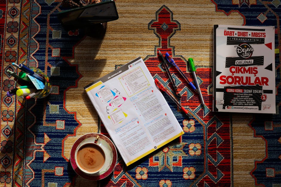 Top view of study materials and coffee on a patterned carpet. Perfect for academic or study themes.