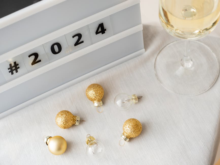 Festive New Year 2024 setup with champagne and golden decorations.