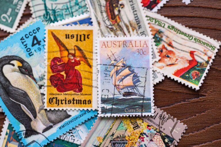 A diverse collection of vintage and international postage stamps displayed on a wooden surface.